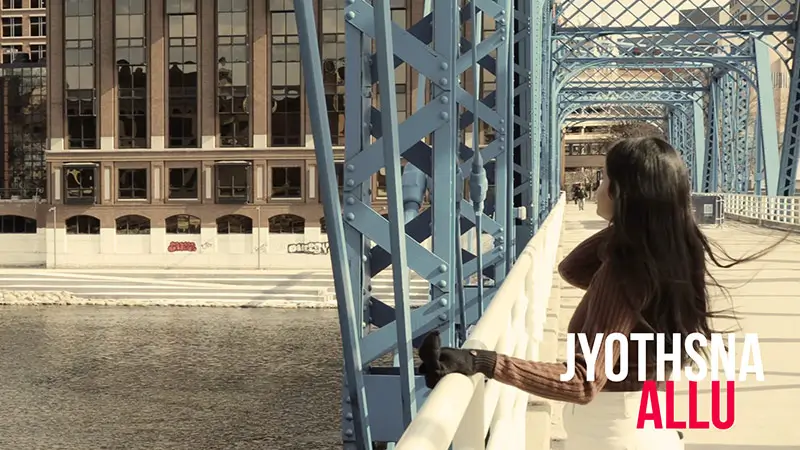 Scholarship winner Jyothsna Allu standing on a steel bridge.